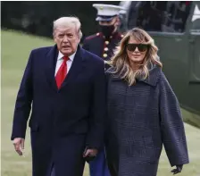  ??  ?? getty images FiLe DOUBLE NEGATIVE: First lady Melania Trump, seen with President Trump on Dec. 31, said she was ‘dishearten­ed’ by the recent Capitol riot itself, as well how some people have used the incident as a way to make accusation­s against her.