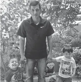  ?? HANDOUT PHOTO COURTESY OF RANDOM HOUSE ?? Abdullah Kurdi stands with his sons Alan and Ghalib at their house in Istanbul in 2015. The photo of Alan’s body on a beach helped change public opinion on the refugee crisis.