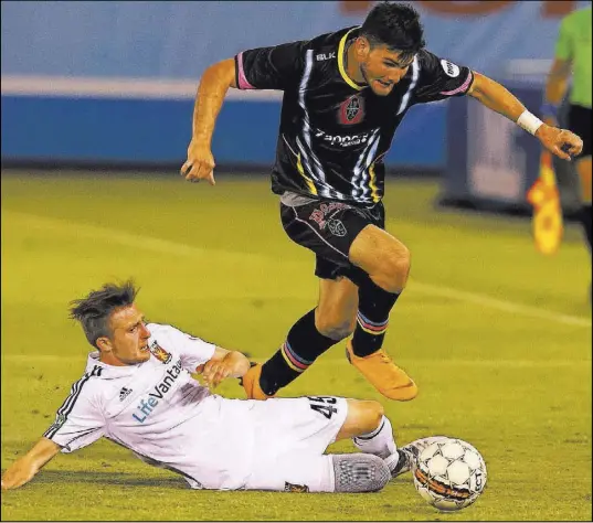  ?? Richard Brian Las Vegas Review-Journal @vegasphoto­graph ?? Lights FC midfielder/forward Matt Thomas breaks away from Real Monarchs SLC defender Andrew Brody (45) during their United Soccer League match Saturday at Cashman Field. Real Monarchs won 2-0.