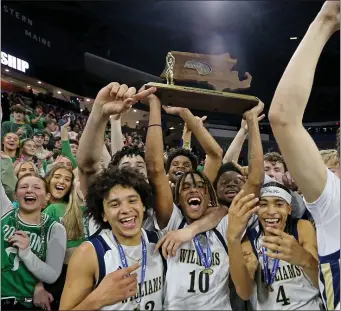  ?? STUART CAHILL — BOSTON HERALD ?? Archbishop Williams players celebrate their Division 3 state title win over St. Mary’s on Saturday at the Tsongas Center in Lowell.