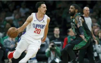  ?? MICHAEL DWYER — THE ASSOCIATED PRESS ?? New Clipper Landry Shamet (20) drives past Boston’s Kyrie Irving (11) during the first half in Boston on Saturday. Shamet, traded by the Sixers this week, had 17 points.