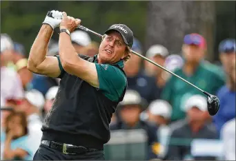  ?? CURTIS COMPTON/CCOMPTON@AJC.COM ?? Phil Mickelson tees off on the 17th hole at Augusta National Golf Club on Thursday. His quest to become the oldest Masters champion picked up some momentum on the back nine.