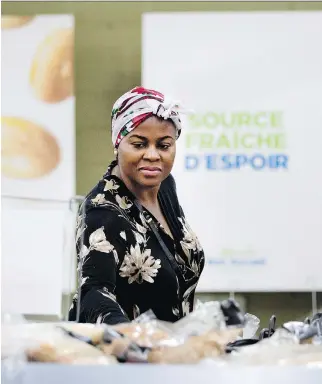  ?? ALLEN MCINNIS ?? Juliette Nwigudu peruses the bread selection at the Welcome Hall Mission on Tuesday. To give its clients a more dignified experience, the mission has changed its operation to mimic a grocery store.