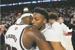  ?? SAM CRAFT/THE ASSOCIATED PRESS ?? Texas A&M guards Tyrece Radford, left, and Wade Taylor hug after beating No. 2 Alabama 67-61 on Saturday in College Station, Texas.