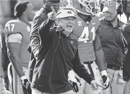  ?? JOHN BAZEMORE/AP ?? Georgia coach Kirby Smart directs players during a game against Missouri on Nov. 6. Georgia and Alabama are the top two defensive teams in the SEC and also sit atop the conference standings.