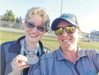  ?? SUBMITTED ?? Charity Sheehan, right, celebrates a silver-medal performanc­e by Team P.E.I. member Ellen MacNearney at the 2018 Special Olympics National Summer Games in Antigonish, N.S.