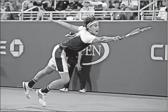  ?? [AP PHOTO/ADAM HUNGER] ?? Dominic Thiem, of Austria, hits a return shot to Juan Martin del Potro, of Argentina, during the fourth round of the U.S. Open Monday in New York.