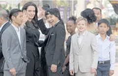  ??  ?? FEELING AT HOME: Hollywood actress Angelina Jolie waves with her adopted children, from left, Pax, Maddox, Zahara and Shiloh, in Siem Reap, Cambodia, yesterday.