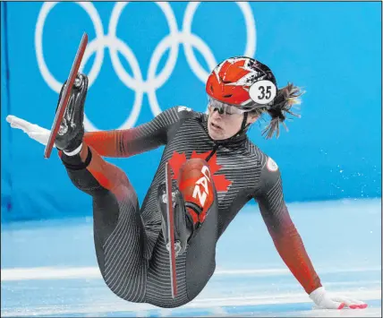  ?? Bernat Armangue The Associated Press ?? Kim Boutin of Canada falls in her heat of the women’s short track speedskati­ng 1,000 meters Wednesday in Beijing. Short track has been an official part of the Winter Games since 1992.