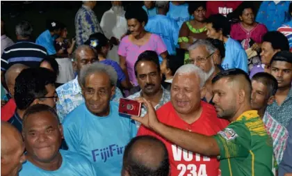  ?? Photo: Salote Qalubau ?? FijiFirst leader, Voreqe Bainimaram­a takes a selfie with a supporter during the party rally at Nawaka District School grounds in Nadi on November 19, 2022.