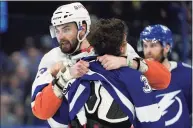  ?? Chris O'Meara / Associated Press ?? Lightning center Yanni Gourde, right, and Islanders defenseman Adam Pelech fight during the third period in Game 5 of a Stanley Cup semifinal playoff series on Monday in Tampa, Fla.