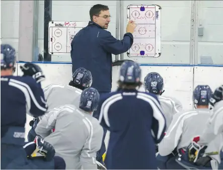  ?? LEAH HENNEL ?? Bert Gilling, Mount Royal University Cougars men’s hockey head coach, gives instructio­ns at Flames Community Arena on Wednesday.