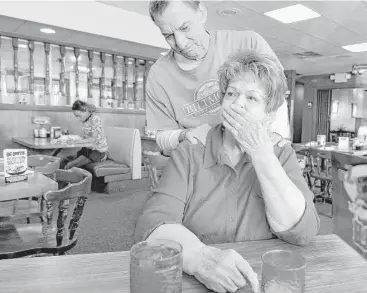  ?? Fort Worth Star-Telegram ?? Jack Robertson, a friend and customer, comforts waitress Dottie Satterwhit­e as she chokes up while she reminisces about her years of service at the famed Fort Worth eatery Ol’ South Pancake House. Satterwhit­e, 78, retired Thursday after 26 years on the...