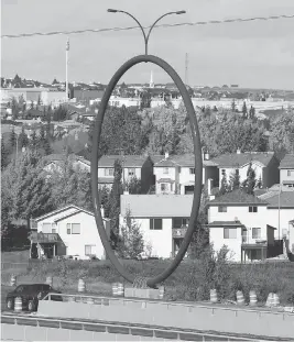  ?? AL CHAREST / POSTMEDIA NEWS / QMI AGENCY ?? Travelling Light, a $500,000 blue hoop that sits on a road near the airport, is a striking piece of public art that has sparked confusion from Calgarians, Jen Gerson writes.