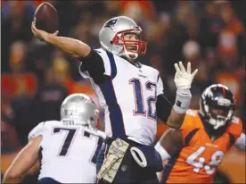  ?? The Associated Press ?? New England Patriots quarterbac­k Tom Brady (12) throws as Denver Broncos linebacker Shaquil Barrett (48) pursues during NFL action this past Sunday in Denver. On Sunday, the Patriots face the Oakland Raiders below the border in Mexico City.