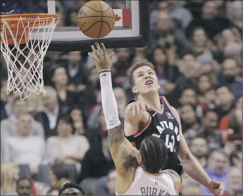  ?? STAN BEHAL/TORONTO SUN ?? Raptors centre Jakob Poeltl tries to swat away an attempt by New York’s Trey Burke during last night’s Raptors win.