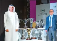  ?? — KT PHOTO BY SHIHAB ?? Major General Dr. Mohammed Essa Al Adhab, Board Member and Executive Director of Dubai Racing Club, and Erwan Charpy, Racing Advisor, Dubai Racing Club, with the nine trophies which will be presented to the winners on Fashion Friday.