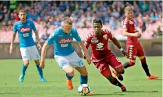  ?? — AP ?? Napoli midfielder Piotr Zielinski (left) and Torino midfielder Afriyle Acquah vie for the ball during their Italian league match at the San Paolo stadium in Naples, Italy, on Monday. The match ended 2-2.