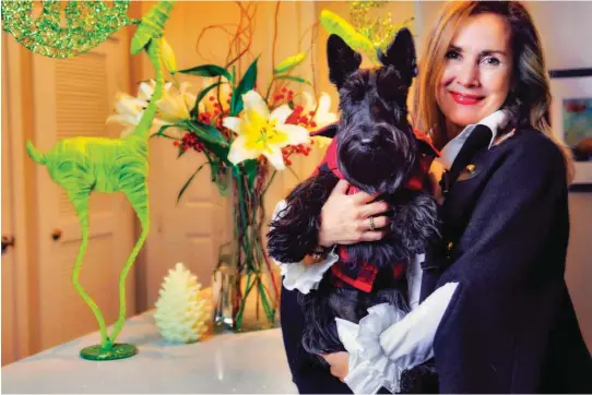  ?? [ PHOTO BY CHRIS LANDSBERGE­R, THE OKLAHOMAN] ?? Janis Bevers poses for a photo with her dog Max at her home in Oklahoma City.