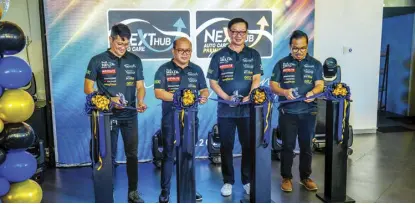  ?? ?? Cutting the ceremonial ribbon to signify the simultaneo­us launch of Nexthub’s seven locations are (from left): ACCS General Manager Ken Rosales, Nexthub General Manager Manny Yator, Autohub Group President Willy Tee Ten, and Painthub General Manager Toto Boces.