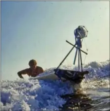  ?? BOB BAGLEY — BRUCE BROWN FILMS VIA AP ?? In this January, 1963 photo provided by Bruce Brown Films, filmmaker Bruce Brown tries to control a surfboard with a mounted camera mounted while making one of his many surfing movies. Brown, whose 1966 surfing documentar­y “The Endless Summer” molded...