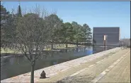  ?? (AP/Sue Ogrocki) ?? A visitor sits March 28 next to the reflecting pool at the Oklahoma City National Memorial and Museum in Oklahoma City.