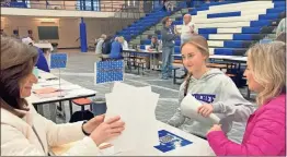  ?? Adam Carey ?? Student Taylor Burns and her mother, Ashley Burns, discuss Taylor’s academic future with math teacher Gina Magnicheri at the first ever Bridge Day at Armuchee High School.