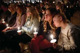  ?? ASSOCIATED PRESS ?? A girl leans on her friend’s shoulder as they listen to Jessi Holt, pastor at Lakepoint Community Church, during a prayer vigil at the church after the Oxford High School school shooting on Tuesday in Oxford, Michigan.