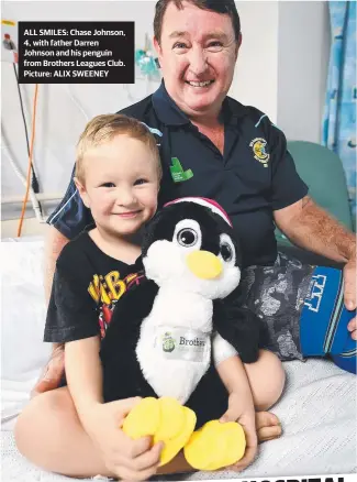  ?? ALL SMILES: Chase Johnson, 4, with father Darren Johnson and his penguin from Brothers Leagues Club. Picture: ALIX SWEENEY ??