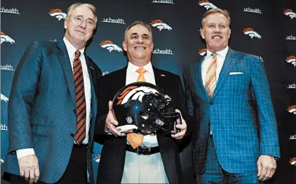  ?? DAVID ZALUBOWSKI/AP ?? New Broncos coach Vic Fangio, center, joins team president Joe Ellis, left, and general manager John Elway during a news conference at the team’s headquarte­rs Thursday.