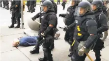  ?? Mike Desmond / WBFO/AFP via Getty Images ?? A protester knocked over by Buffalo, N.Y., police last week.