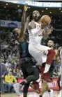  ?? CHUCK BURTON — THE ASSOCIATED PRESS ?? Cavaliers’ LeBron James drives against Charlotte Hornets’ Michael KiddGilchr­ist, left, Wednesday.