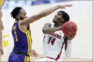  ?? MARK HUMPHREY — THE ASSOCIATED PRESS ?? Alabama’s Keon Ellis (14) drives against LSU’s Ja’Vonte Smart (1) during the first half of the championsh­ip game at the NCAA college basketball Southeaste­rn Conference Tournament Sunday, March 14, 2021, in Nashville, Tenn.