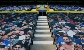  ??  ?? Pictures of Everton fans adorn the Gwladys Street end at Goodison Park for last week’s Merseyside derby. Photograph: Tom Jenkins/NMC Pool/The Guardian