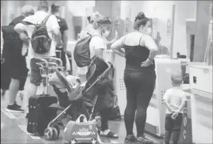  ?? REUTERS/Borja Suarez ?? British tourists returning to UK, check in their luggage, as Britain imposed a two-week quarantine on all travellers arriving from Spain, following the coronaviru­s disease (COVID-19) outbreak, at Gran Canaria Airport, on the island of Gran Canaria, Spain July 25, 2020.