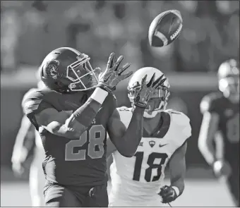  ?? SUE OGROCKI/AP PHOTO ?? Oklahoma State’s James Washington catches a pass in front of TCU’s Nick Orr and takes it in for a touchdown in the first quarter of Saturday’s game in Stillwater, Okla. The 14th-ranked Cowboys upset No. 5 TCU, 49-29.