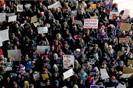  ?? PHOTO: REUTERS ?? People gather to protest against the travel ban imposed by US President Donald Trump’s executive order, at O’Hare airport in Chicago, Illinois.