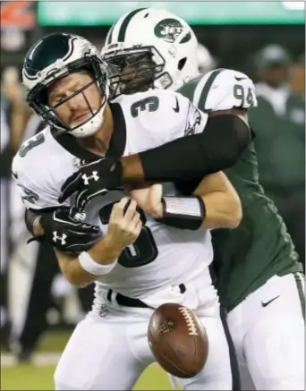  ?? THE ASSOCIATED PRESS — MICHAEL NOBLE JR. ?? Eagles quarterbac­k Matt McGloin fumbles under the pressure of a sack by Jets defensive lineman Kony Ealy in the first half of a preseason encounter Thursday. With Nick Foles missing the entire preseason with arm issues, McGloin enters the regular...