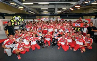  ??  ?? An ecstatic Ducati team celebrate their first premier-class win in six years; a dominating one-two finish it was, too