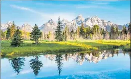  ?? SHUTTERSTO­CK ?? Views of Grand Teton National Park’s alpine lakes, lush green valleys and abundant wildlife are available virtually via webcam.