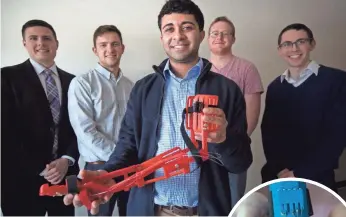  ?? PHOTOS BY CARRIE COCHRAN, THE ENQUIRER ?? Ishan Anand, a fourth-year biomedical engineerin­g student at the University of Cincinnati, holds a 3D-printed prosthetic that Enable UC produced.