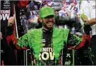  ?? AP PHOTO BY NAM Y. HUH ?? Martin Truex Jr. celebrates with his crew in Victory Lane after winning a NASCAR Cup Monster Energy Series auto race at Chicagolan­d Speedway in Joliet, Ill., Sunday.