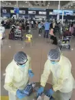  ??  ?? Medical screening staff at Dubai Internatio­nal Airport