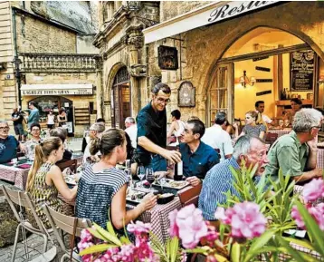  ?? DOMINIC ARIZONA BONUCCELLI/RICK STEVES’ EUROPE PHOTOS ?? Lingering in outdoor cafes is the norm in France — eat long and well. A good meal is a three-hour joyride for the senses.