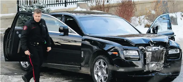  ?? GAVIN YOUNG / POSTMEDIA NEWS FILES ?? Police investigat­e the Rolls-Royce Ghost driven by Riaz Mamdani, who was shot outside his $7.7-million mansion in a tony Calgary neighbourh­ood.