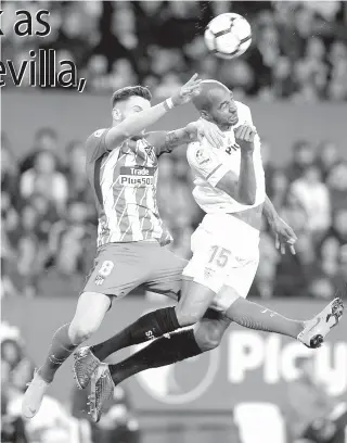  ?? AFP PHOTO ?? Atletico Madrid’s Spanish midfielder Saul Niguez ( left) jumps for the ball with Sevilla’s French midfielder Steven N’Zonzi during the Spanish league football match between Sevilla FC and Club Atletico de Madrid at the Ramon Sanchez Pizjuan stadium in...