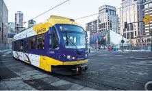  ?? TIM GRUBER FOR THE NEW YORK TIMES ?? Some planners believe too much hope is being put in driverless vehicles. A light rail car in Minneapoli­s.