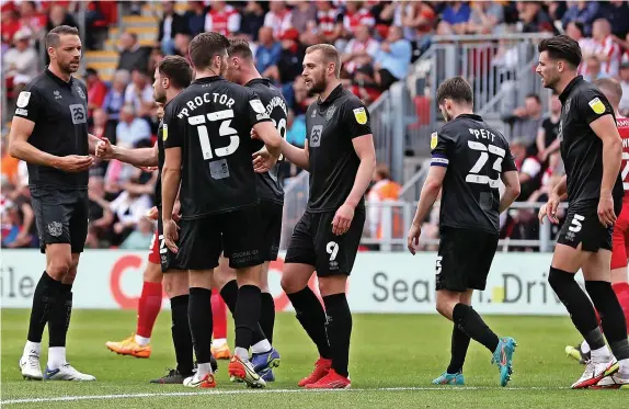  ?? Picture: Gerard Austin ?? WINNING MOMENT: Port Vale’s players congratula­te James Wilson after his goal earned the Valiants a 1-0 win at Exeter City.