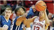  ?? [PHOTO BY BRYAN TERRY, THE OKLAHOMAN] ?? Oklahoma’s Jordan Shepherd, right, fights for the ball with Oral Roberts’ Aaron Anderson during a game this season at Lloyd Noble Center in Norman.