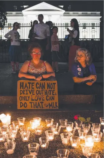  ?? Picture: AFP ?? People gather in front of the White House in Washington, DC for a vigil in response to the death of Heather Heyer at a rally in Charlottes­ville, Virginia.